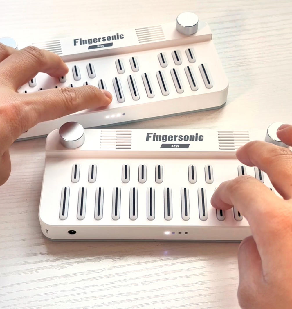 Two Fingersonic Keys used in a piano-style duet performance of Love Story with hands playing melody and harmony